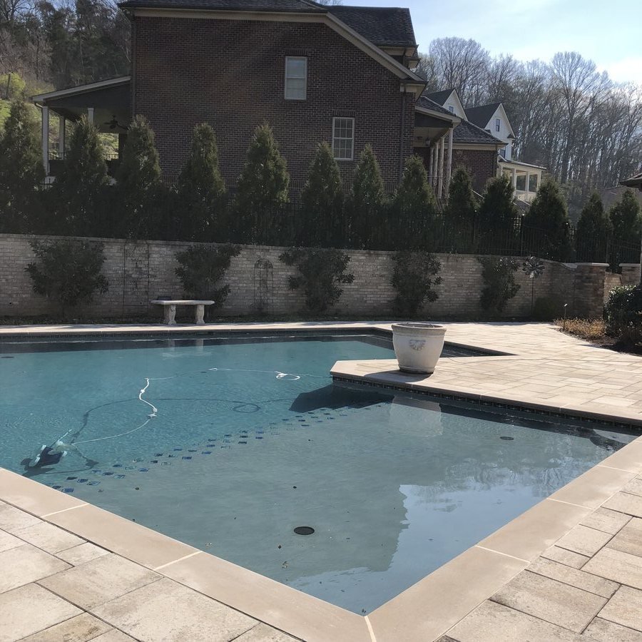 Modern pool with stone surround and water feature
